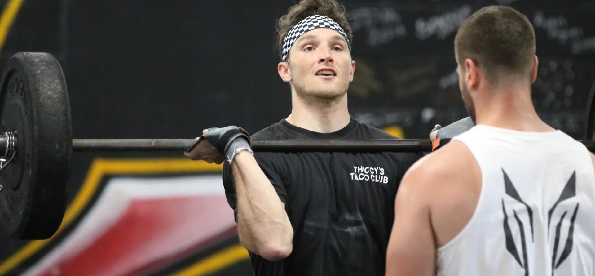 Man lifting weights with coach at CrossFit Danbury